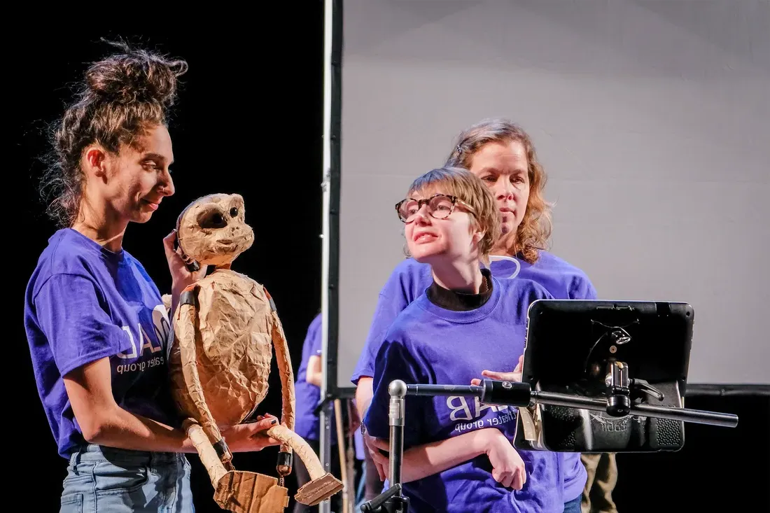 Community actors performing on stage.